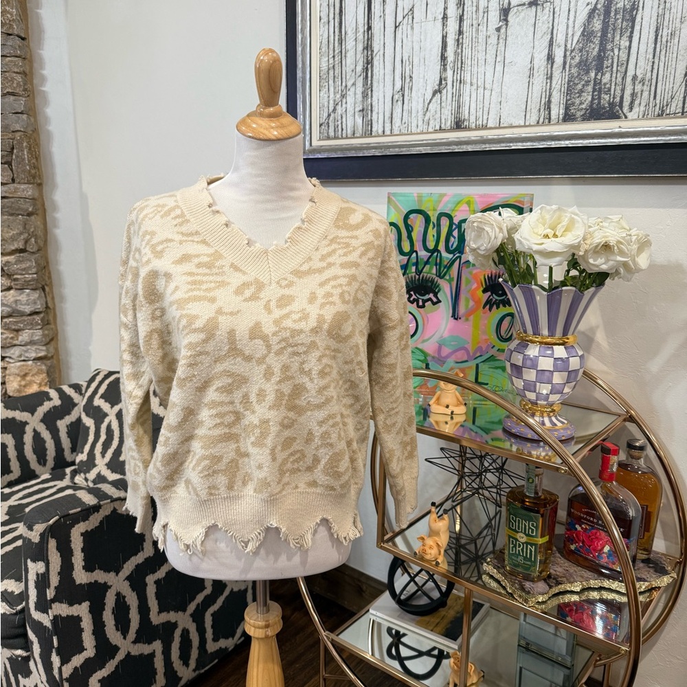 This gorgeous light cheetah print sweater with a ruffled neck!